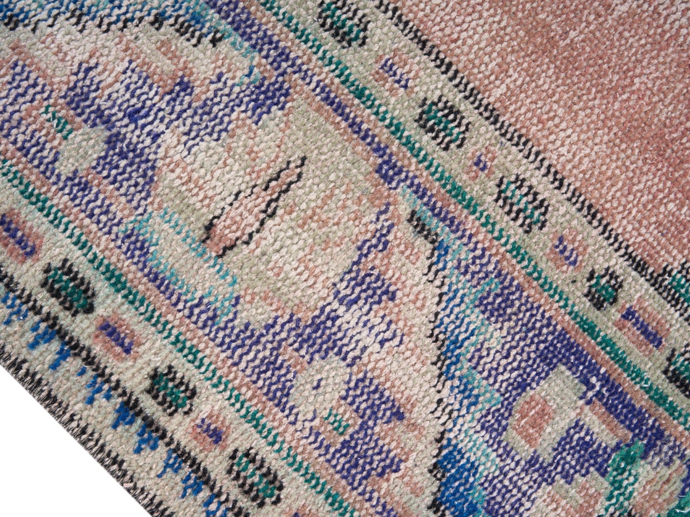 Turkish Manisa area rug in dusty rose and navy, view 6 of 10