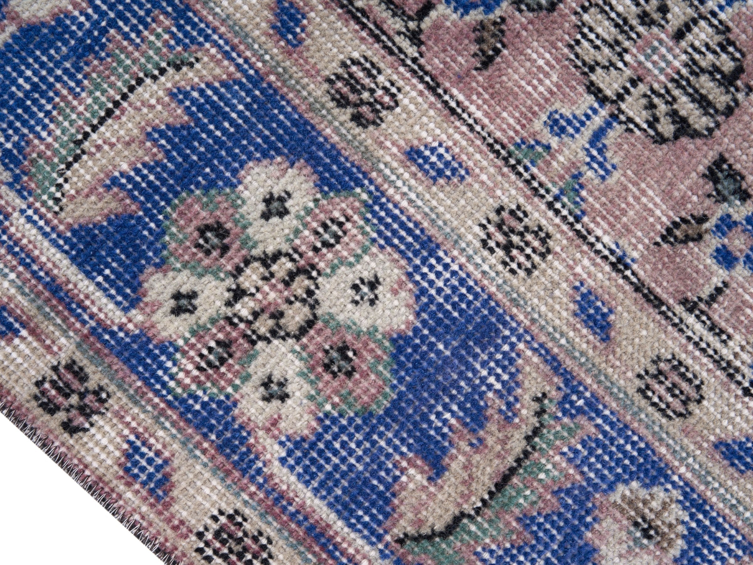 Turkish Isparta area rug in muted pink and dark blue, view 6 of 10
