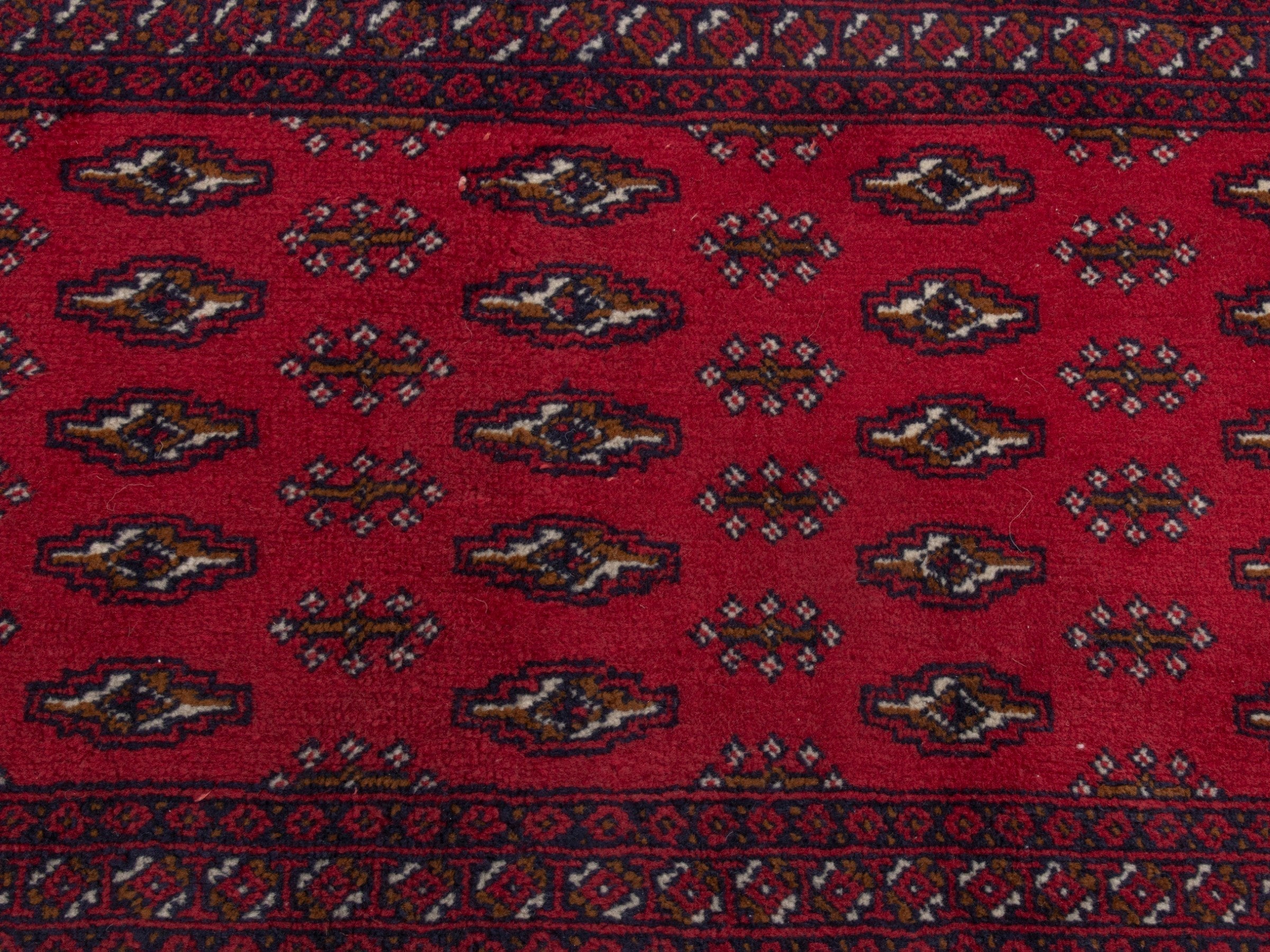 Persian Torkaman accent rug in deep red and burgundy, view 4 of 5