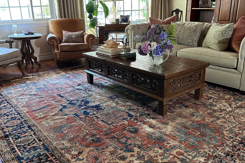 Vintage Persian rug sized correctly under a living room seating group